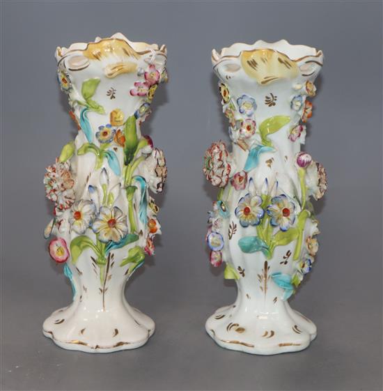 A pair of Victorian floral encrusted porcelain vases height 21cm